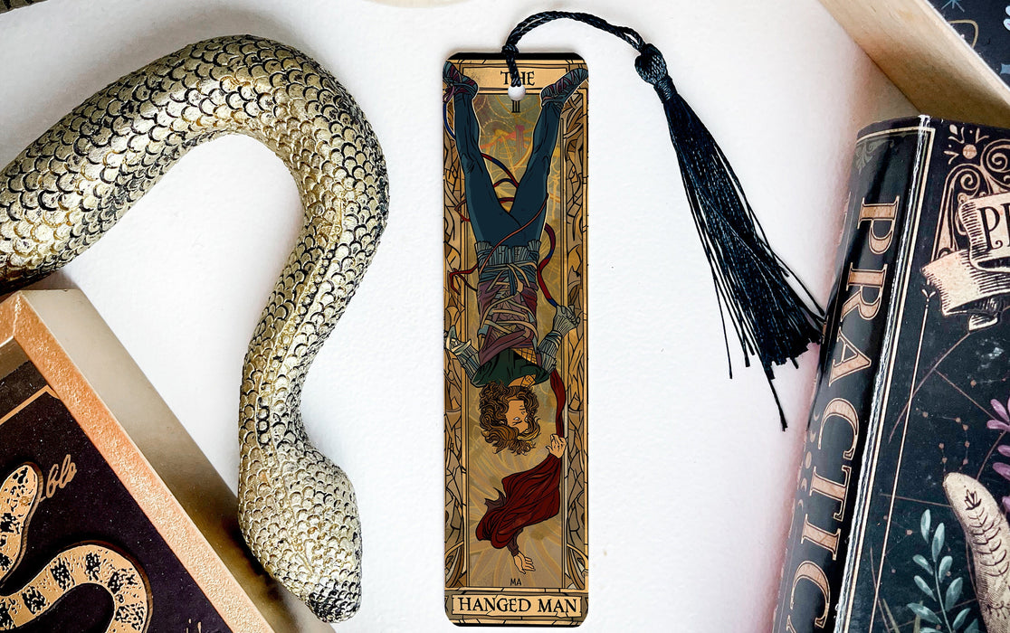 a bookmark with a snake and a book on it