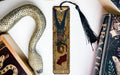 a bookmark with a snake and a book on it