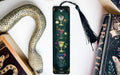 a book with a bookmark and a snake next to it