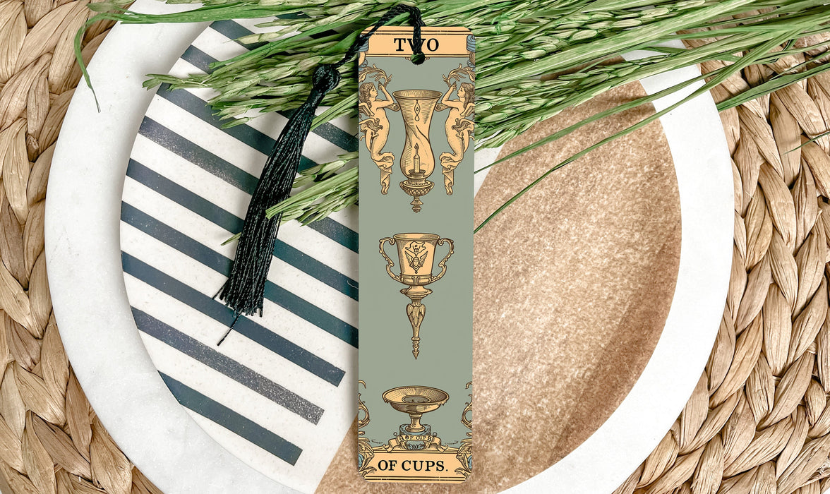 a bookmark with a tassel on top of a plate