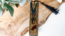 a wooden cross with a tassel hanging from it