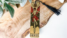 a bookmark with a picture of a devil on it