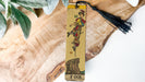 a wooden bookmark with a picture of a woman on it
