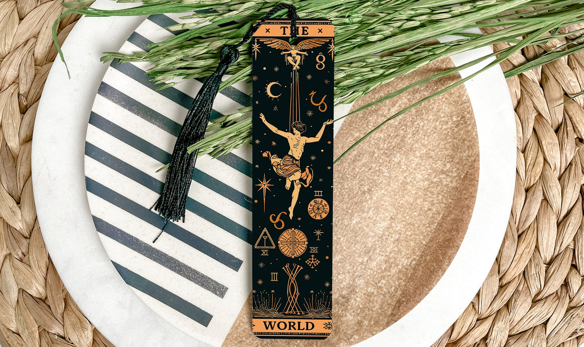 a bookmark with a design on it sitting on a plate