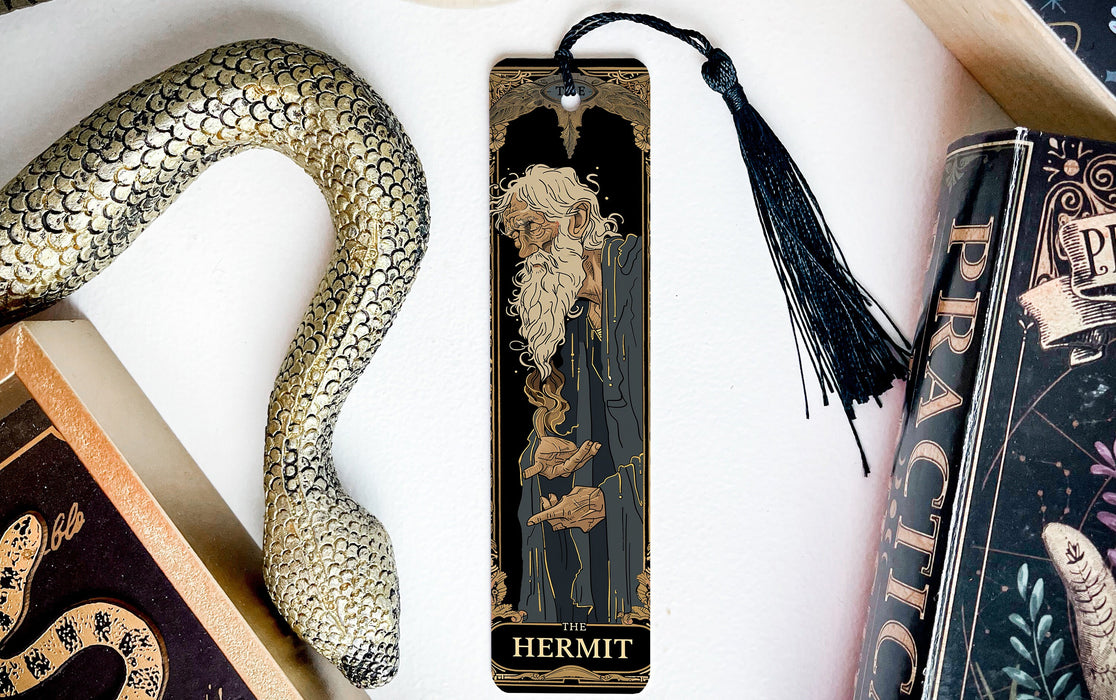 a bookmark with a snake and a book on it