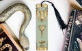 a bookmark with a snake and a cup on it