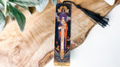 a wooden cross with a tassel hanging from it