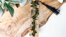 a piece of wood with a tassel on top of it