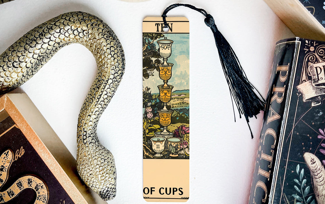 a snake, a bookmark, and some books on a table