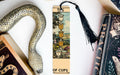 a snake, a bookmark, and some books on a table