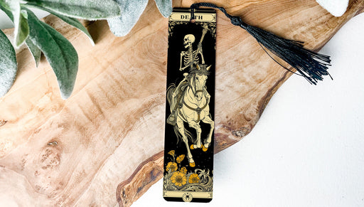 a bookmark with a skeleton riding a horse
