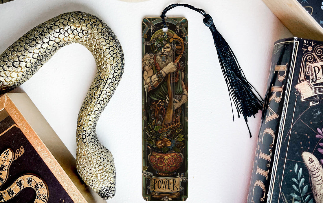 a bookmark with a snake and a book on it