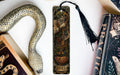 a bookmark with a snake and a book on it