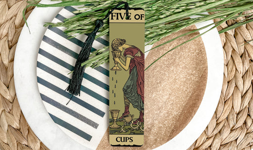 a bookmark with a picture of a woman holding a cup