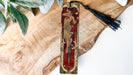 a wooden cross with a tassel hanging from it