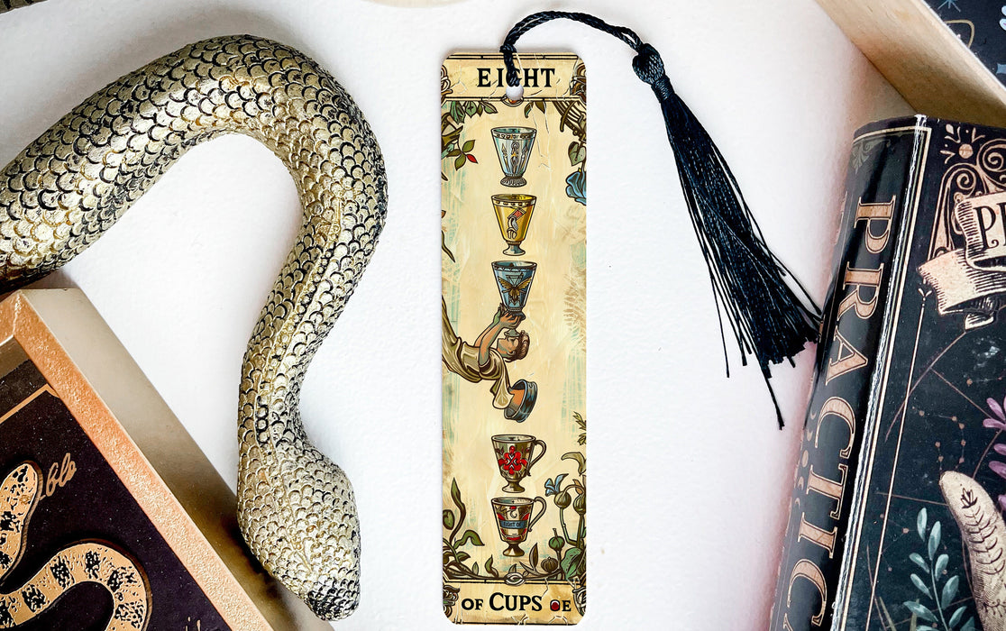 a snake, a bookmark, and some books on a table