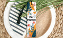 a bookmark that says stay positive on a plate