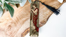 a bookmark with a picture of a woman in a red dress