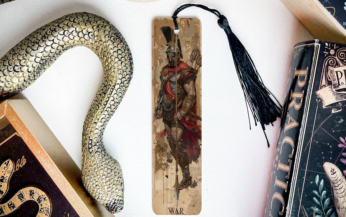 a snake, a bookmark, and some books on a table