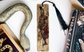a snake, a bookmark, and some books on a table