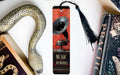 a bookmark with a horn and a snake on it