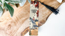 a piece of wood with a tassel on top of it
