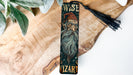 a wooden bookmark with a picture of a wizard on it