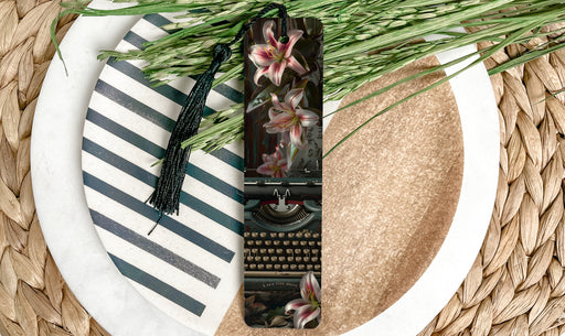a close up of a plate with a typewriter and flowers