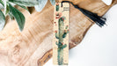a bookmark with a tassel hanging from it