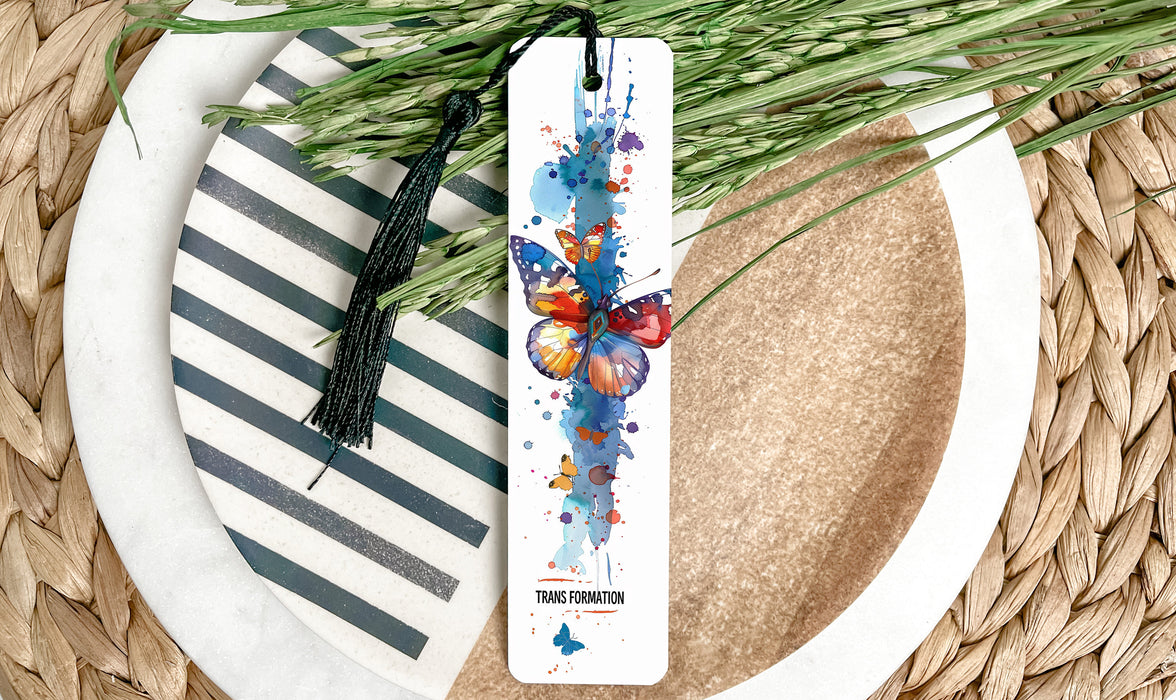 a bookmark with a butterfly on it sitting on a plate