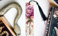 a bookmark with a flower and a snake on it