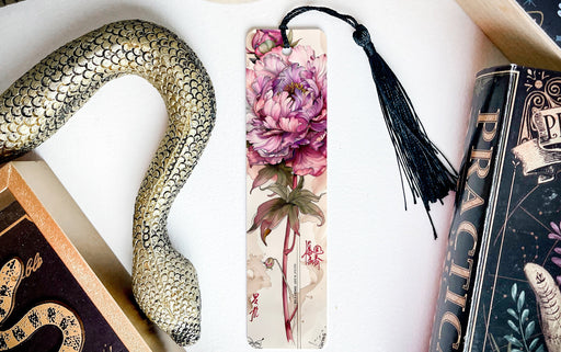 a bookmark with a flower and a snake on it