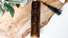 a piece of wood with a tassel on top of it