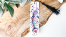 a bookmark with a bird and flowers on it