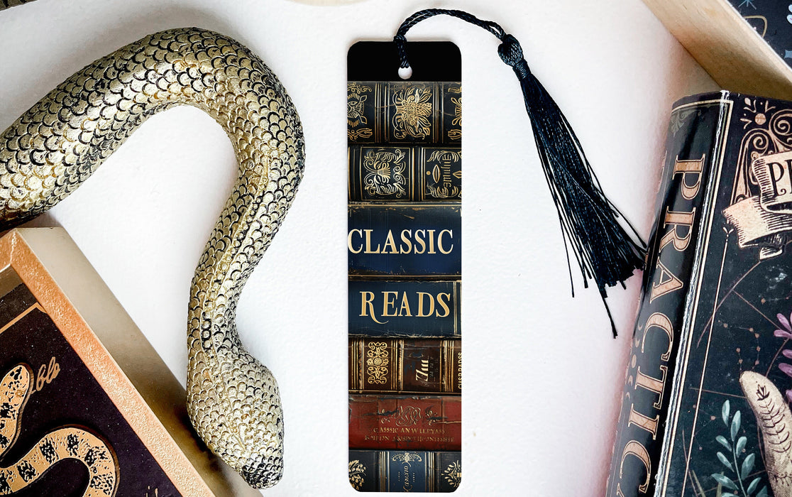 a bookmark with a snake on it next to some books