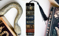 a bookmark with a snake on it next to some books