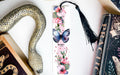 a bookmark with a butterfly and flowers on it