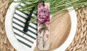 a plate with a flower and a bookmark on it