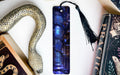 a bookmark with a snake on it next to other books