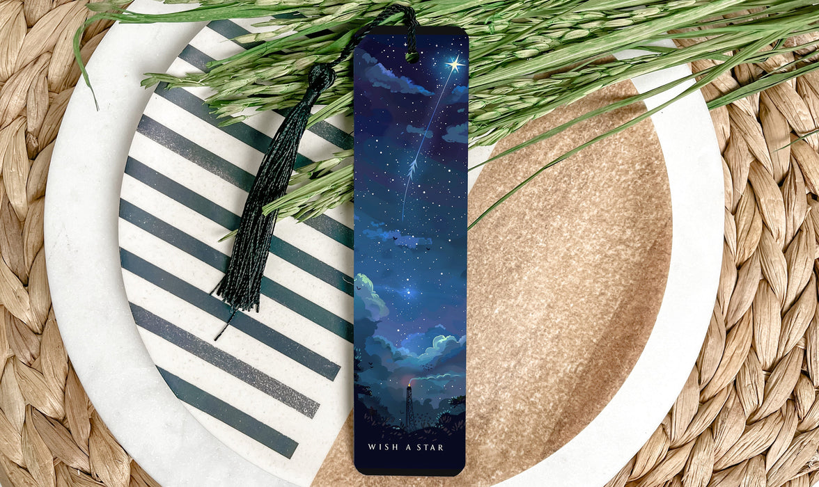 a bookmark sitting on top of a plate next to a plant