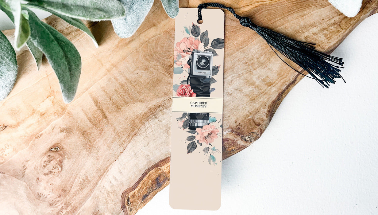 a bookmark with a camera and flowers on it