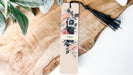 a bookmark with a camera and flowers on it