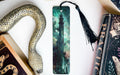 a bookmark, snake, and other books on a table