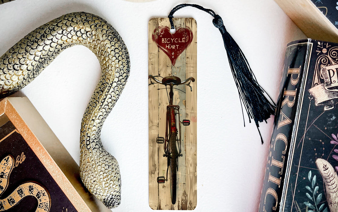 a snake, a bookmark, and some books on a table