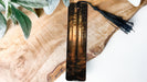 a piece of wood with a tassel hanging from it