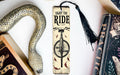 a bookmark with a snake and a bike on it
