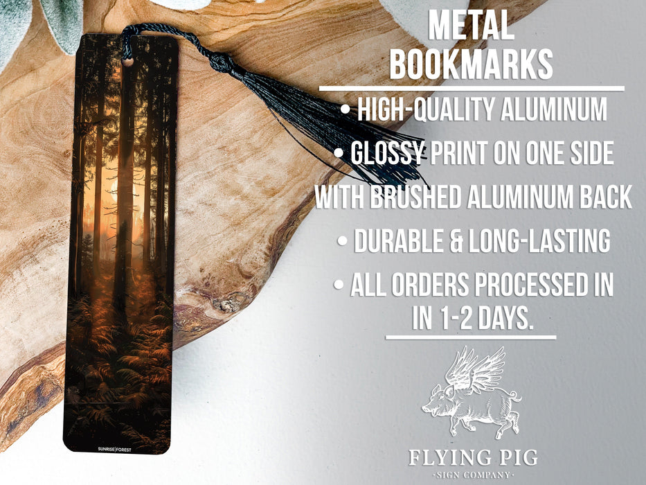 a metal bookmark with a forest scene on it