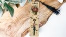a bookmark with a bicycle and flowers on it