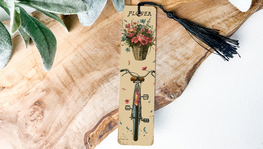 a bookmark with a bicycle and flowers on it
