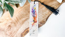 a bookmark with a tassel hanging from it